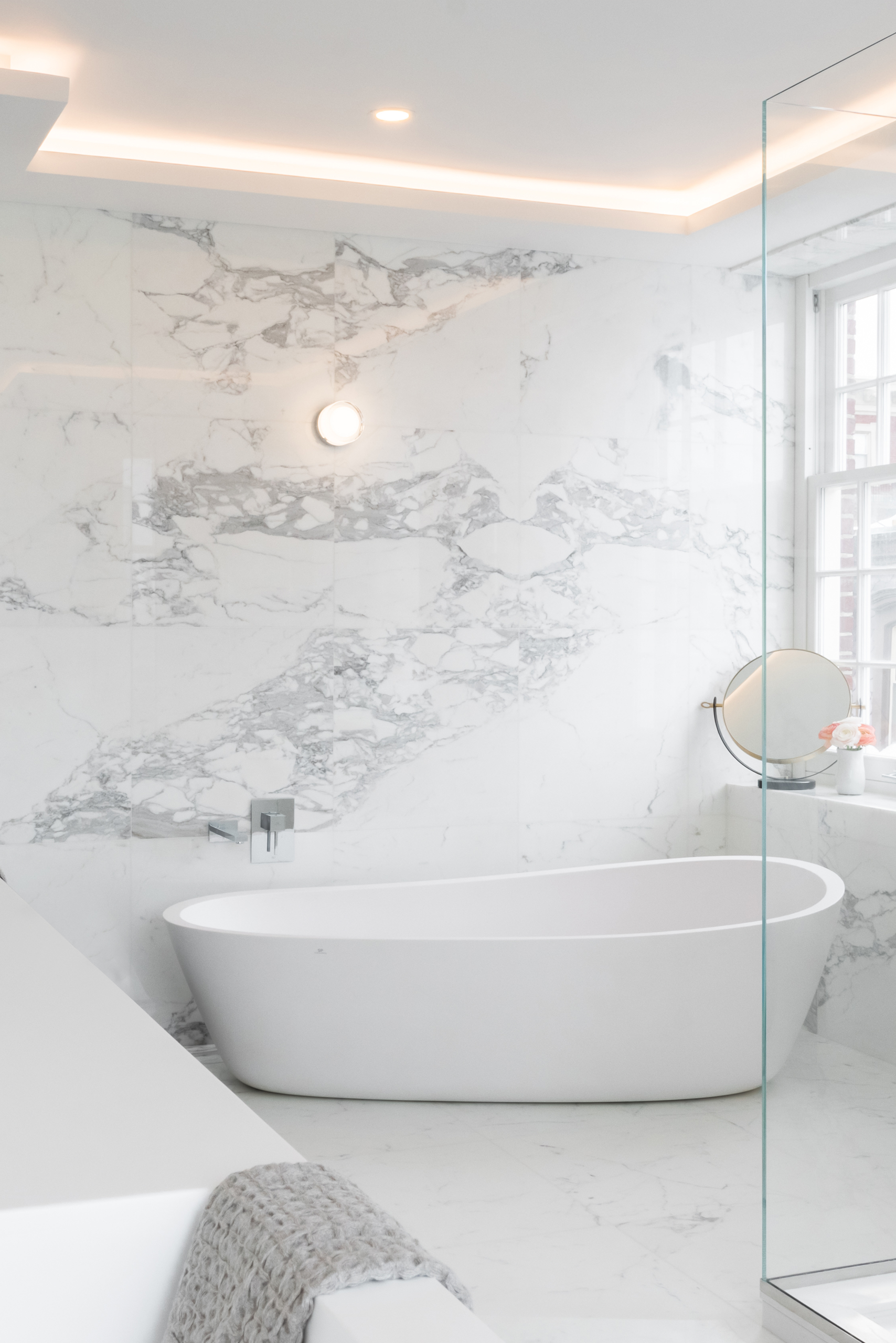 Luxury Carrara marble bathroom in Boston apartment.