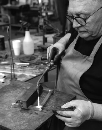 Italian artisan working on light fixture in workshop